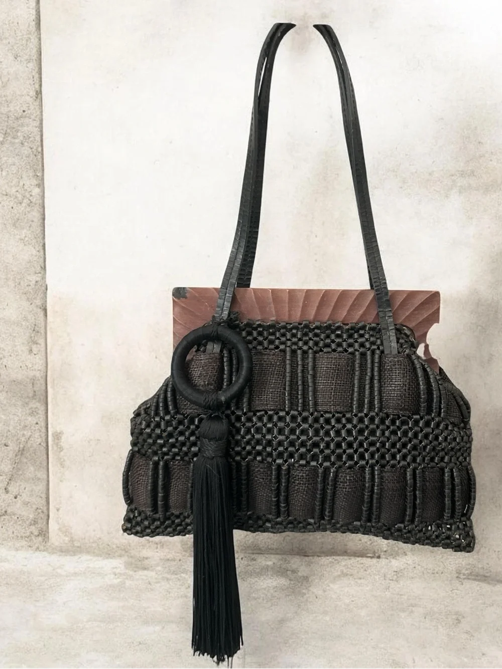 Aranaz Antik Batik tote features a wooden frame woven beaded detail and tassel